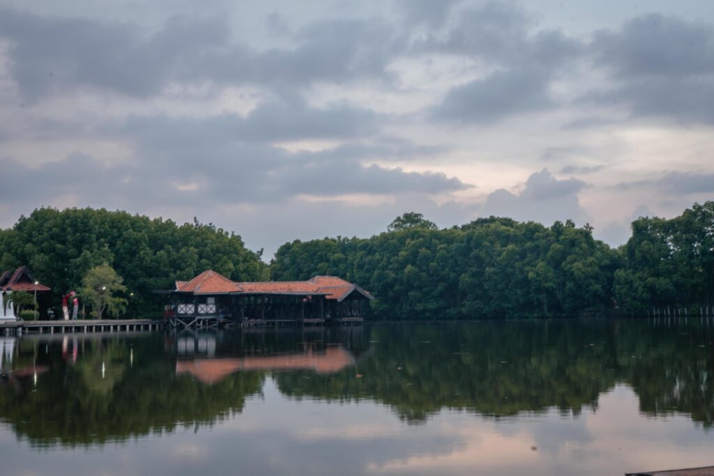 Wooden bridge over the tropical lake with cloudy vibes. The photo is suitable to use for adventure content media, nature poster and forest background. Stock Free