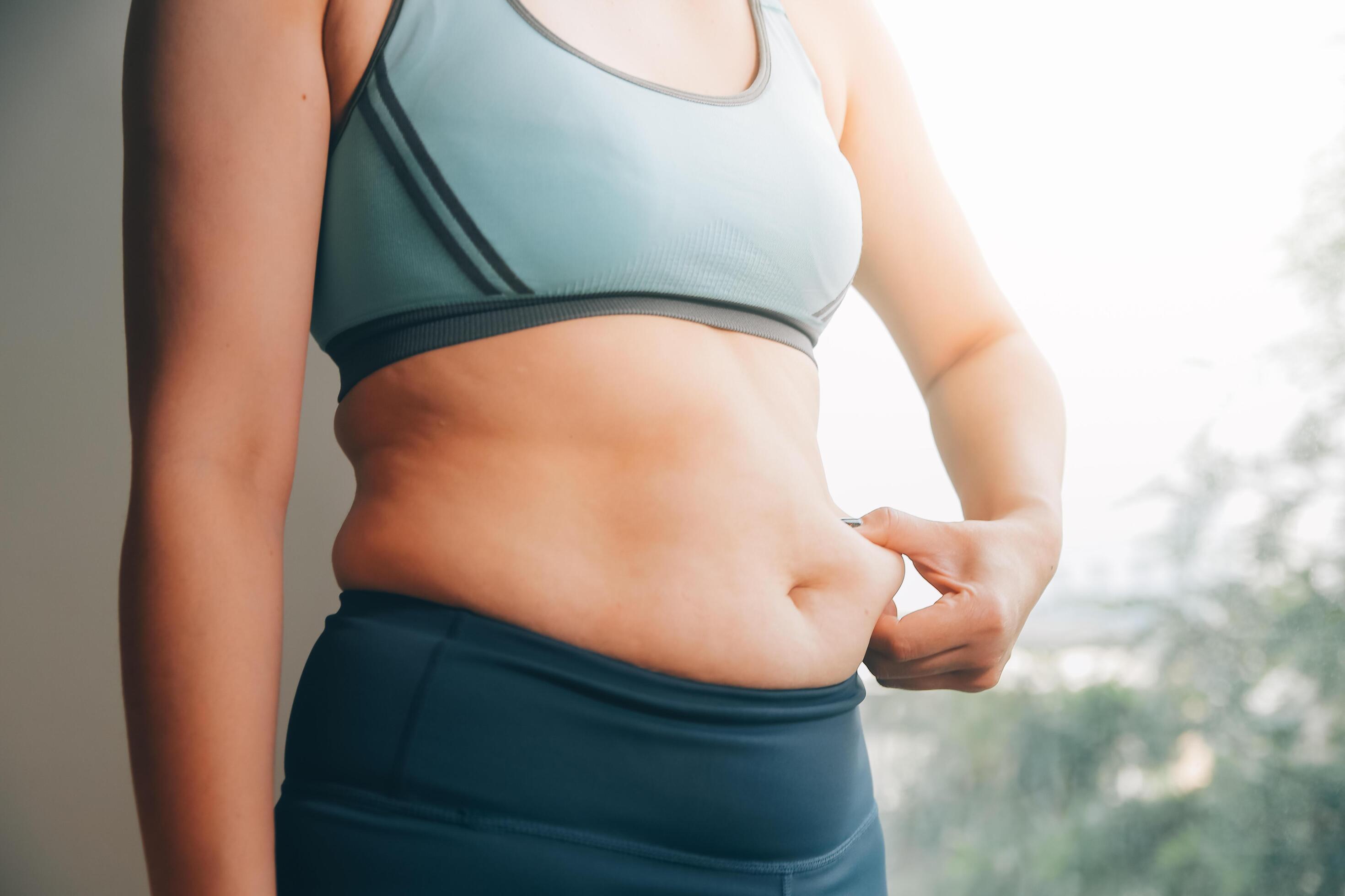 fat woman, fat belly, chubby, obese woman hand holding excessive belly fat with measure tape, woman diet lifestyle concept Stock Free