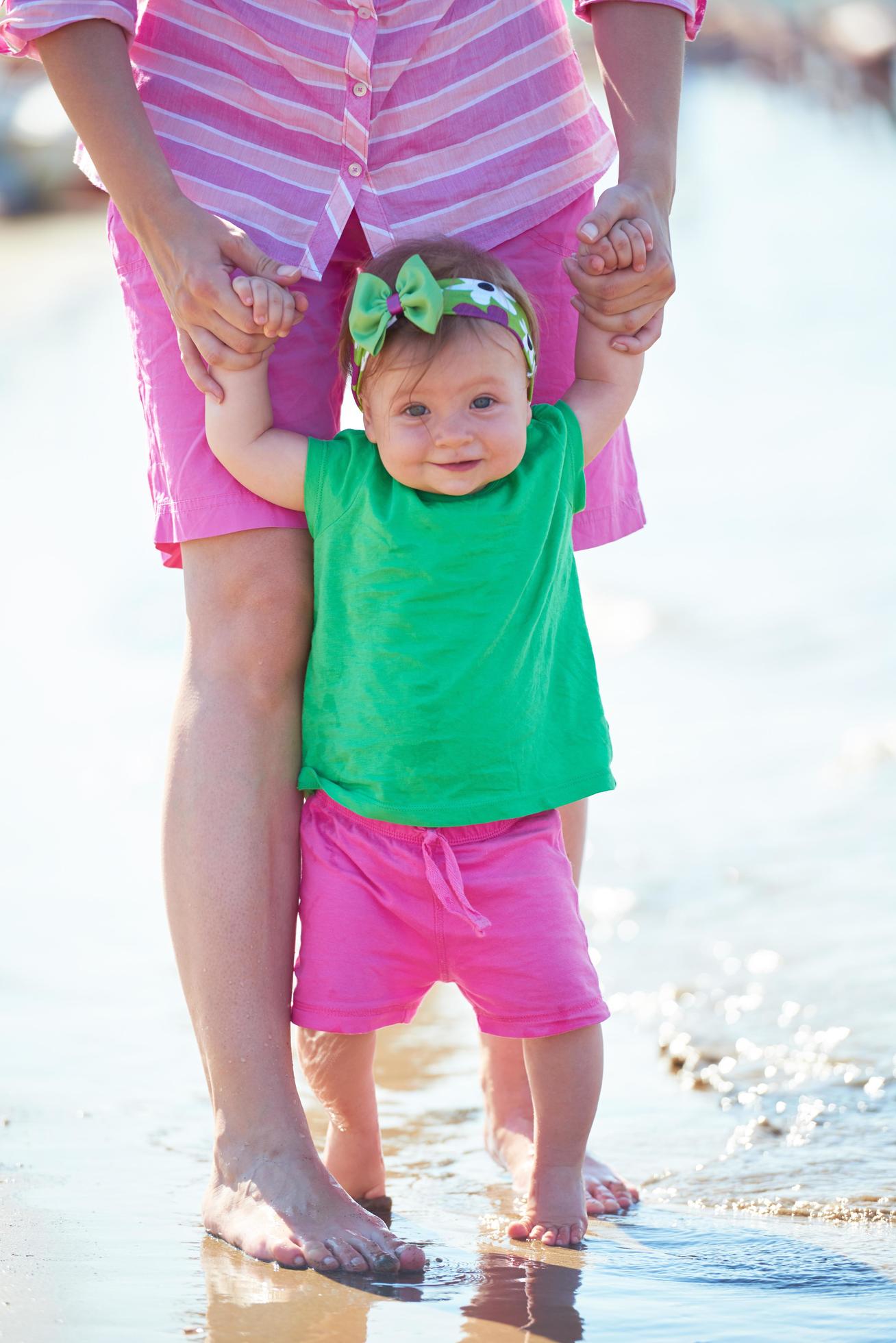 mom and baby on beach have fun Stock Free