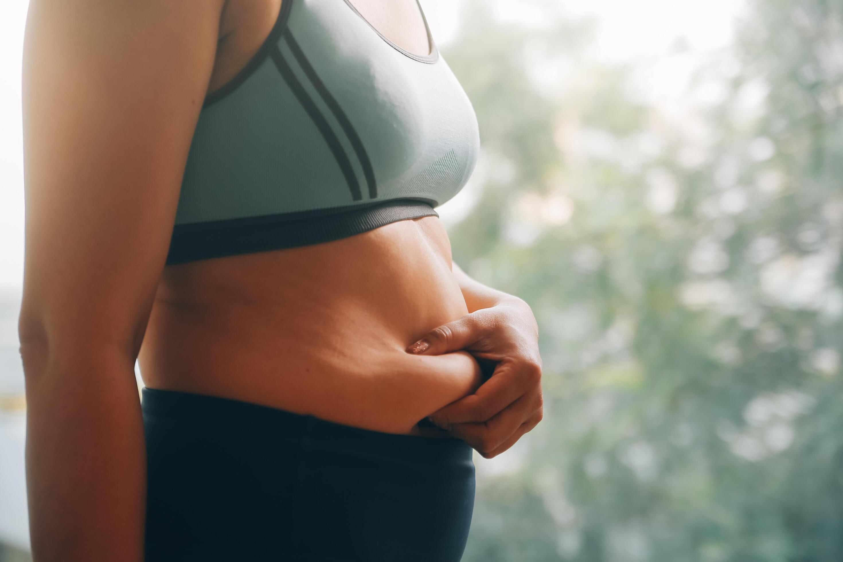 fat woman, fat belly, chubby, obese woman hand holding excessive belly fat with measure tape, woman diet lifestyle concept Stock Free