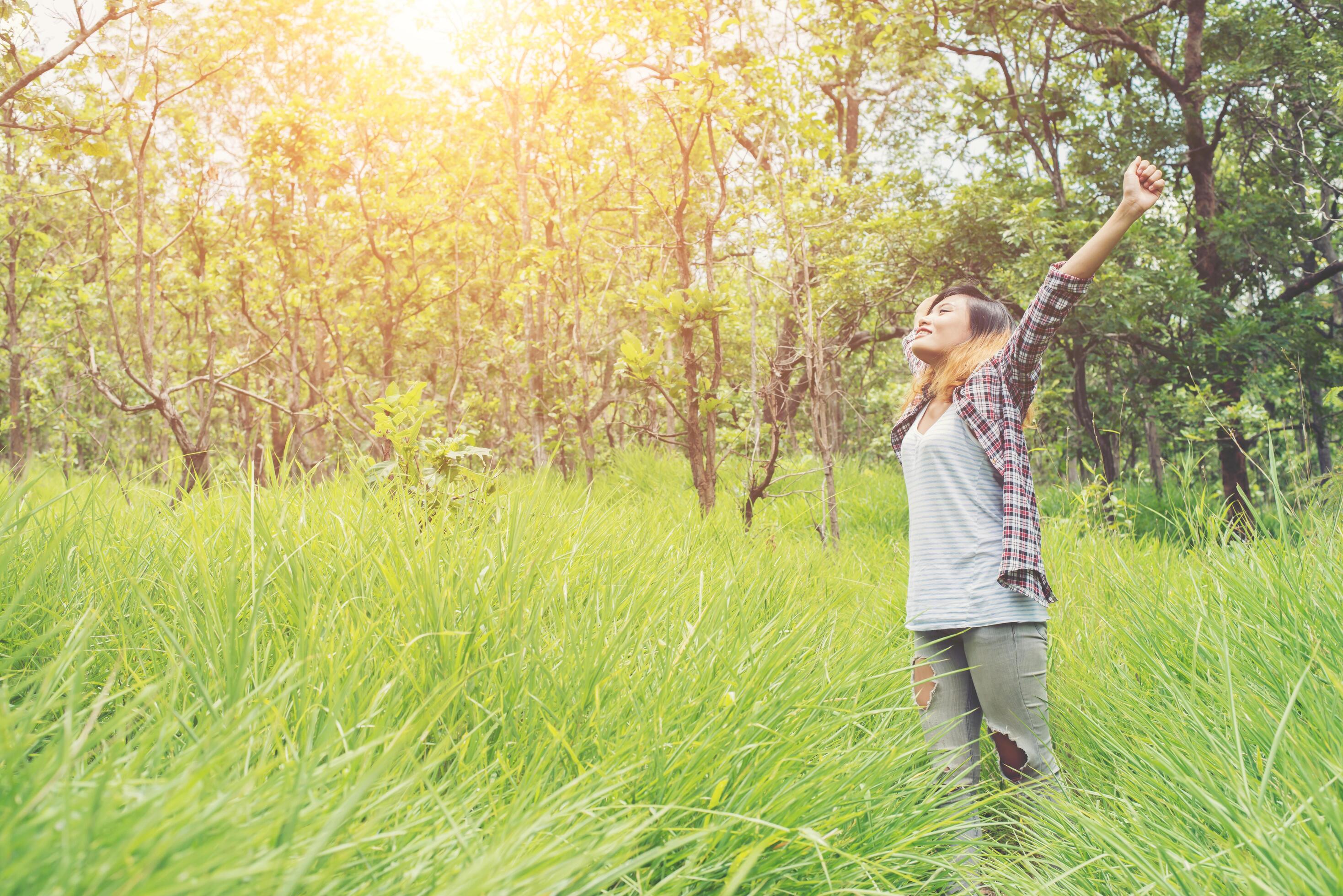 Young woman enjoying nature in the middle of a meadow, Freedom and relaxing. Stock Free