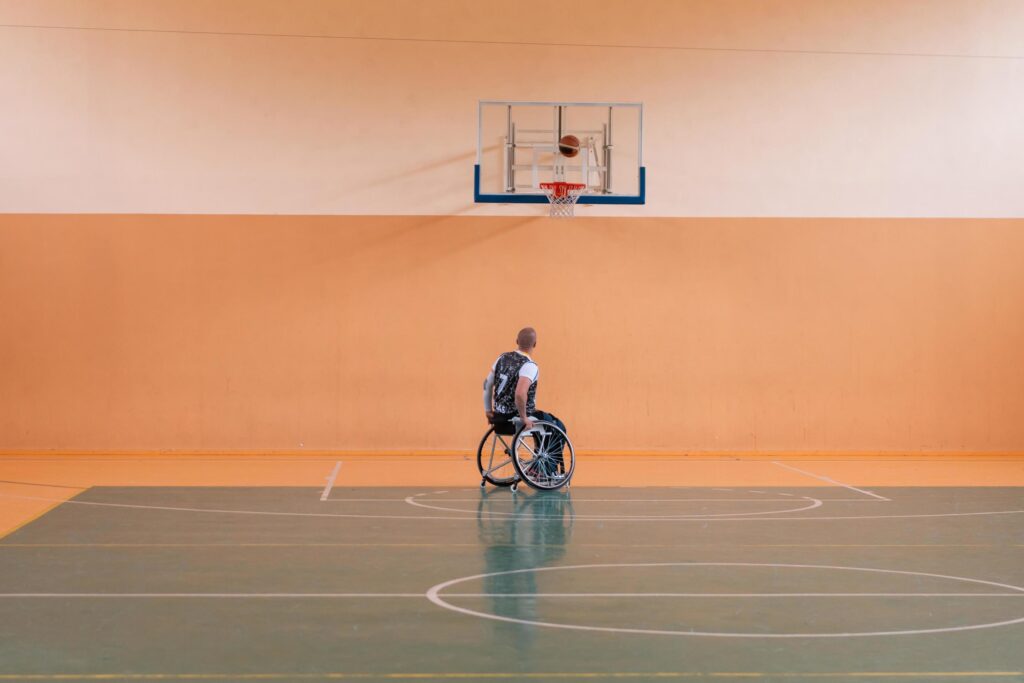 a photo of a war veteran playing basketball in a modern sports arena. The concept of sport for people with disabilities Stock Free