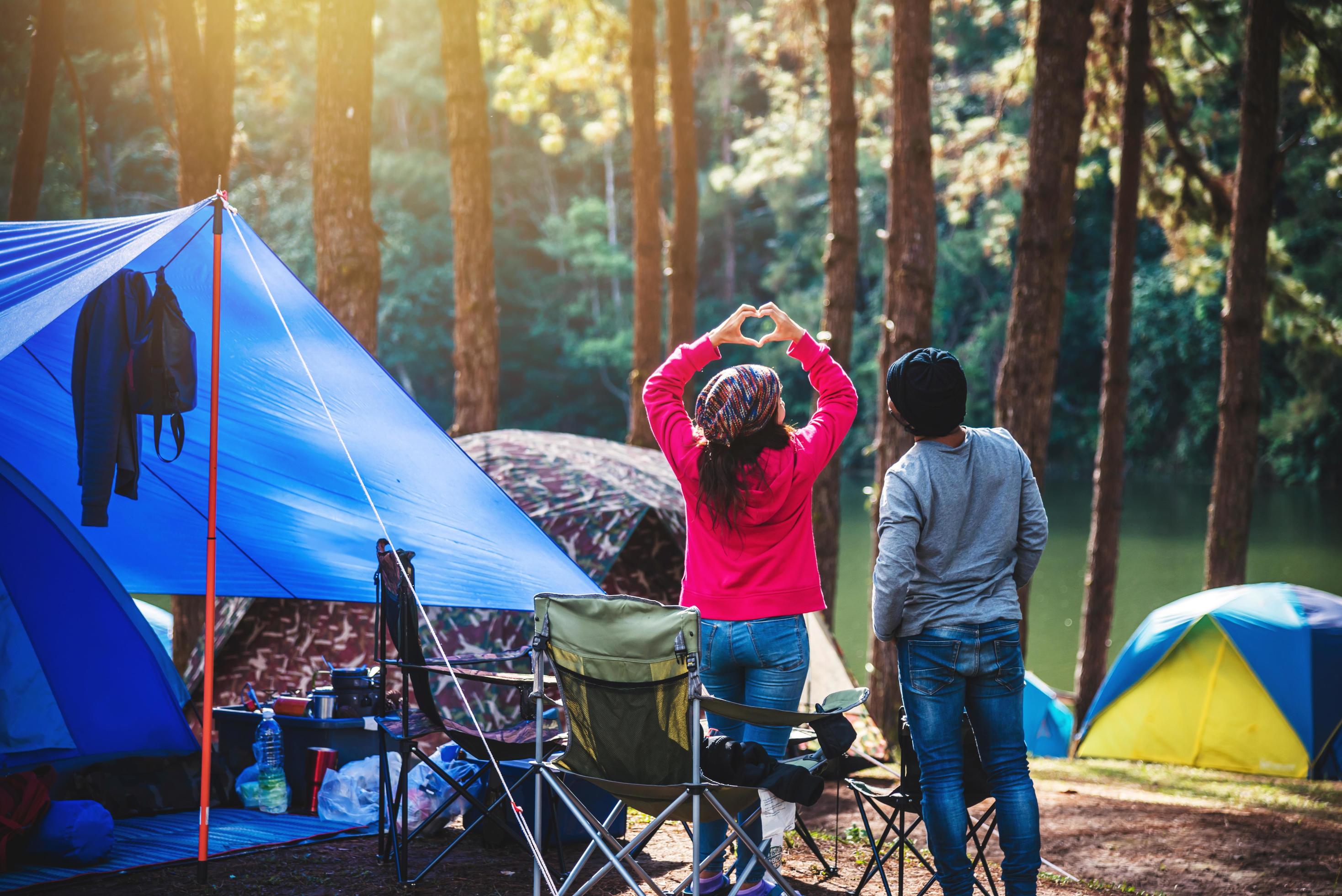 Asian woman travel nature camping on the Mountain see the lake in the mist at morning sunrise at Pang Ung , Mae Hong Son province, Thailand. Stock Free