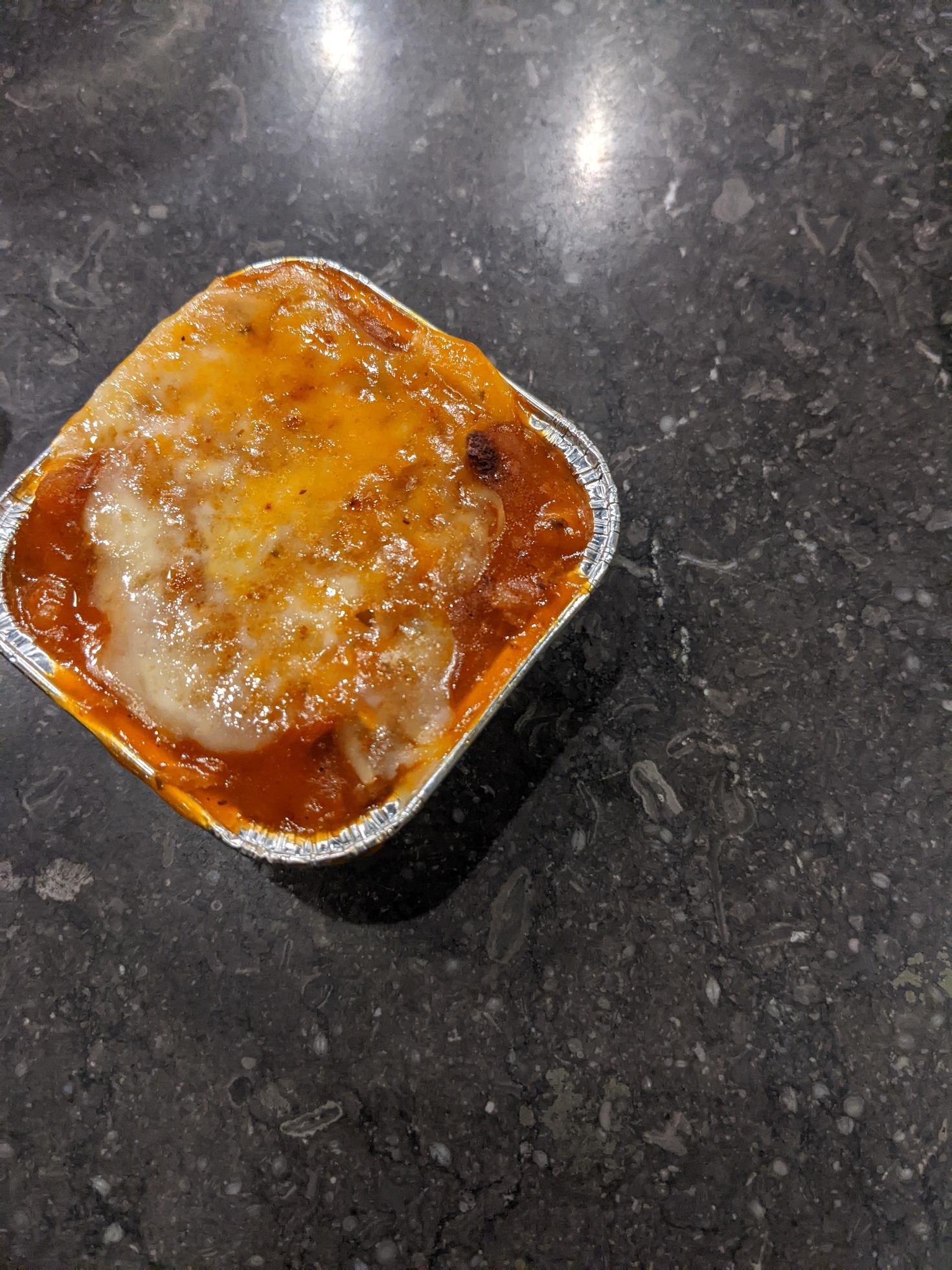 Cedar Cheese and mozzarella on the roasted beef lasagna with chili sauce. The photo is suitable to use for food background, poster and food content media. Stock Free