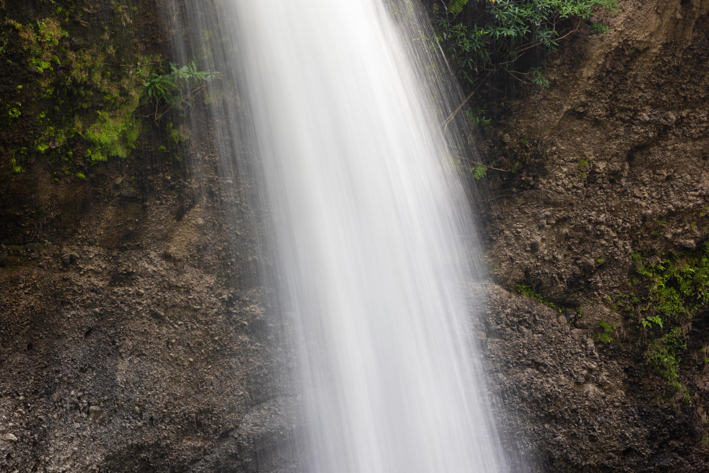 A natural waterfall in a big forest in the midst of beautiful nature. Stock Free