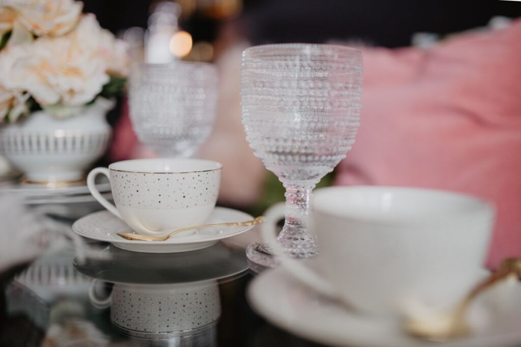 Porcelain and glass dishware on the glass table Stock Free