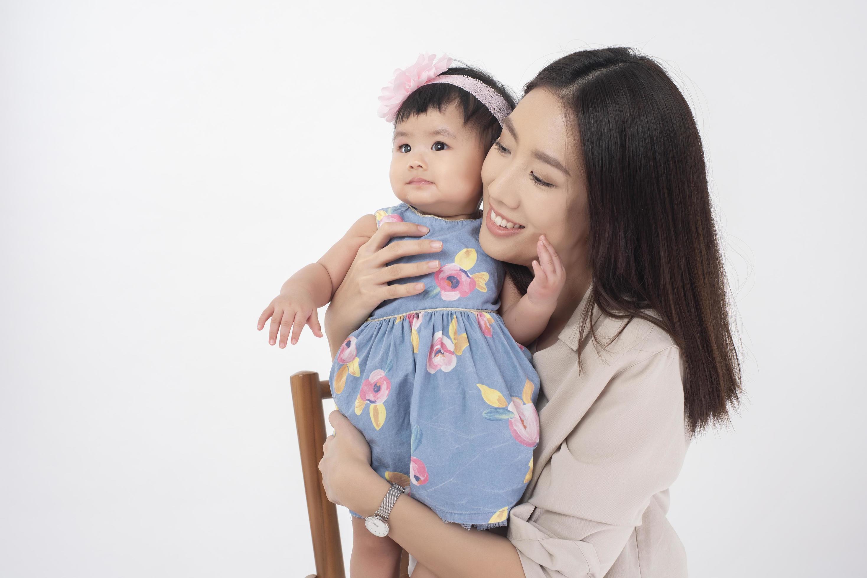 Asian mother and adorable baby girl are happy on white background Stock Free