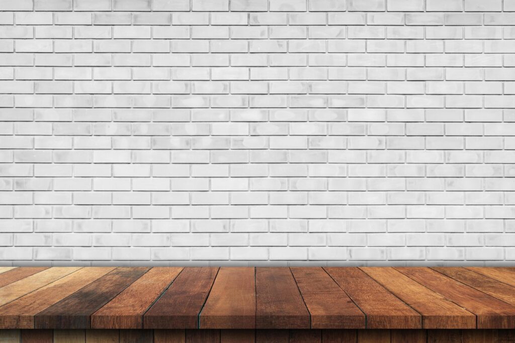 Empty wood table over white brick wall background, product montage display background Stock Free