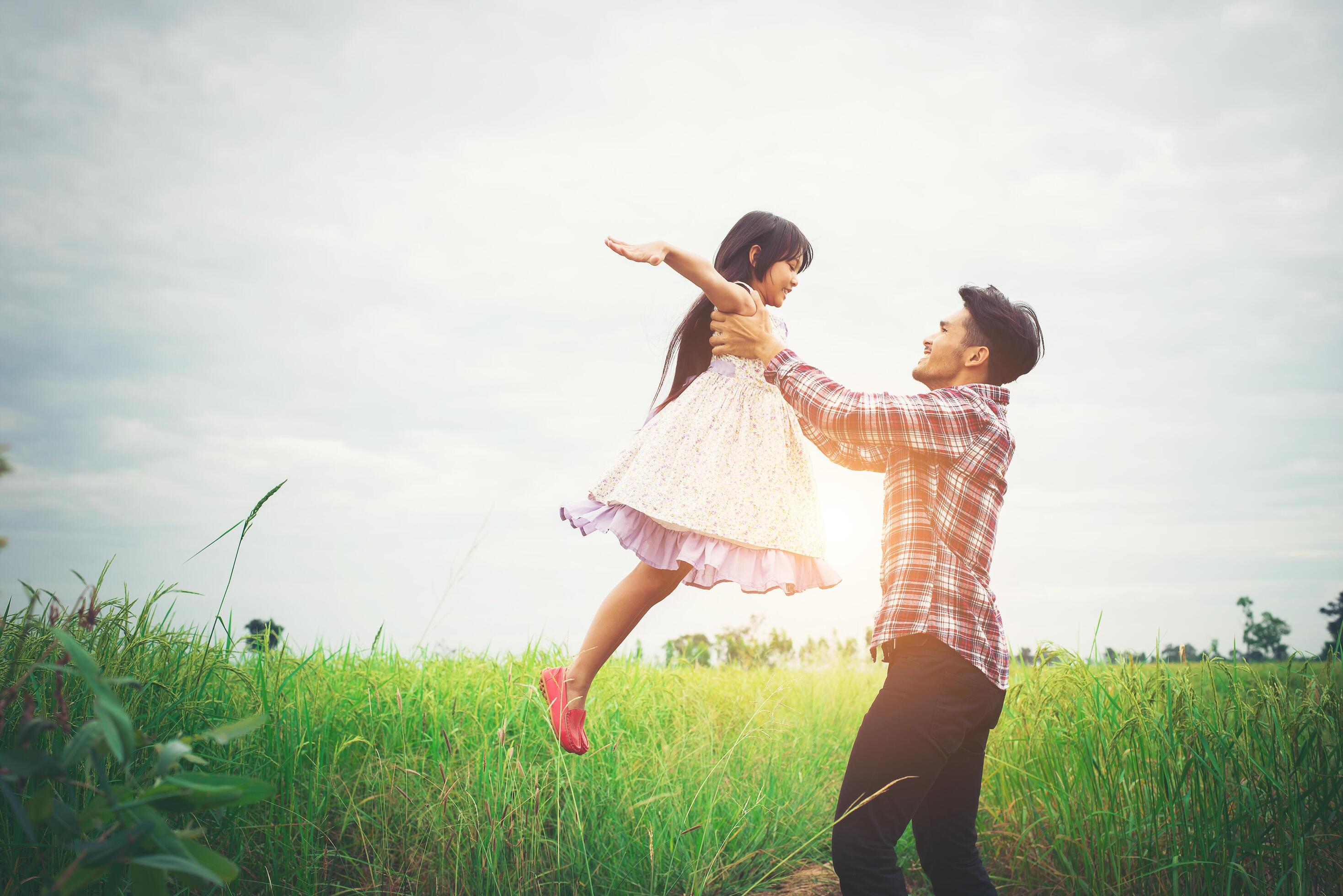 Daddy carrying his daughter with nature and sunlight, enjoyment family. Stock Free