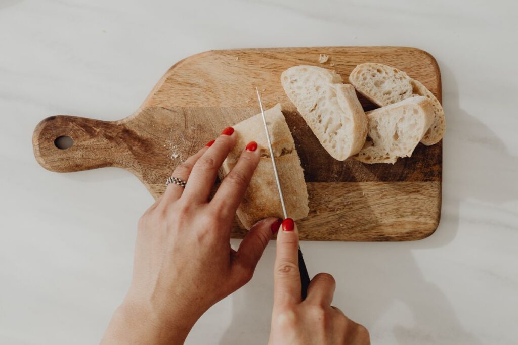 Woman making bruschetta with healthy ingredients Stock Free