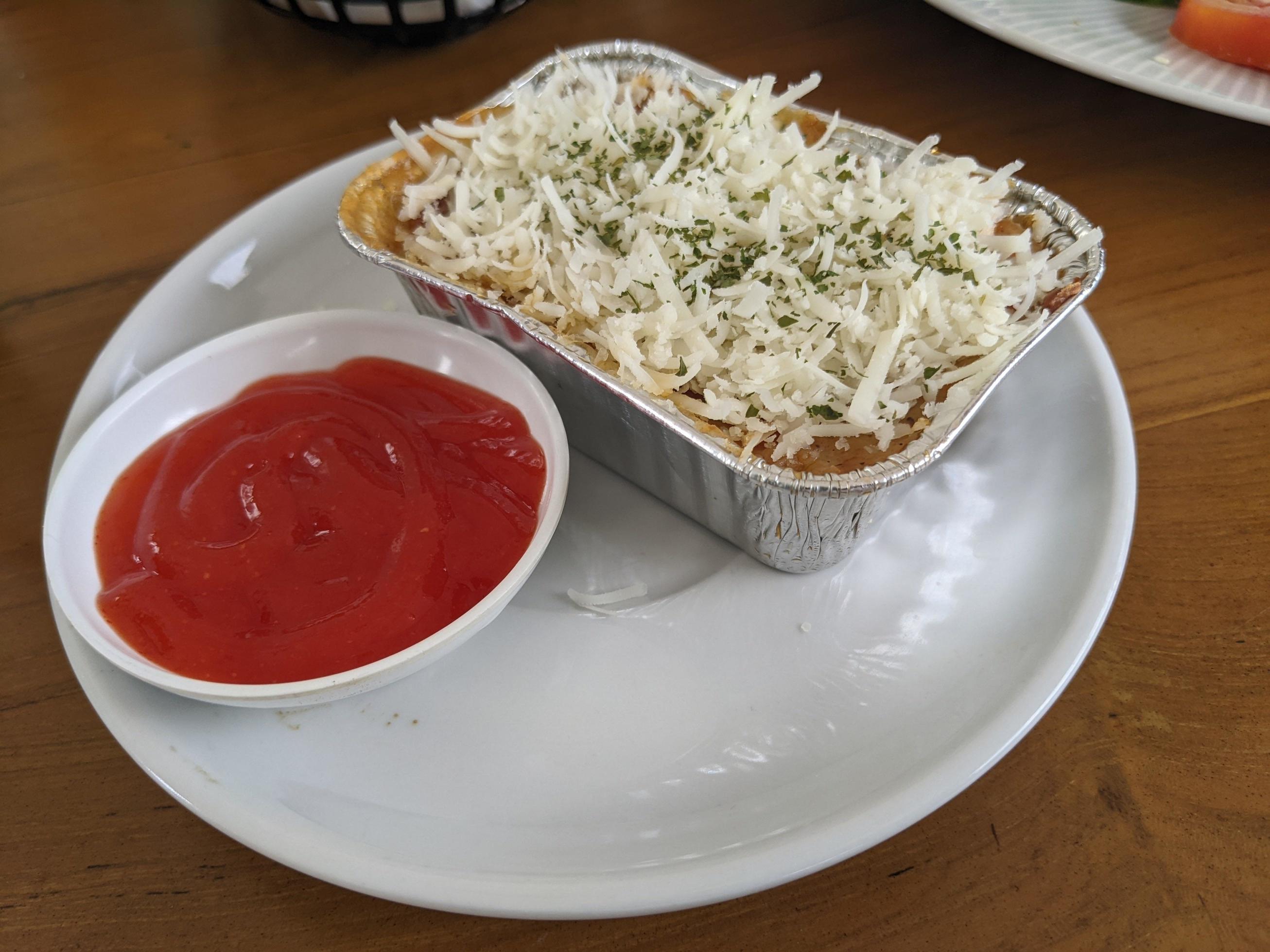 Cedar Cheese and mozzarella on the roasted beef lasagna with chili sauce. The photo is suitable to use for food background, poster and food content media. Stock Free