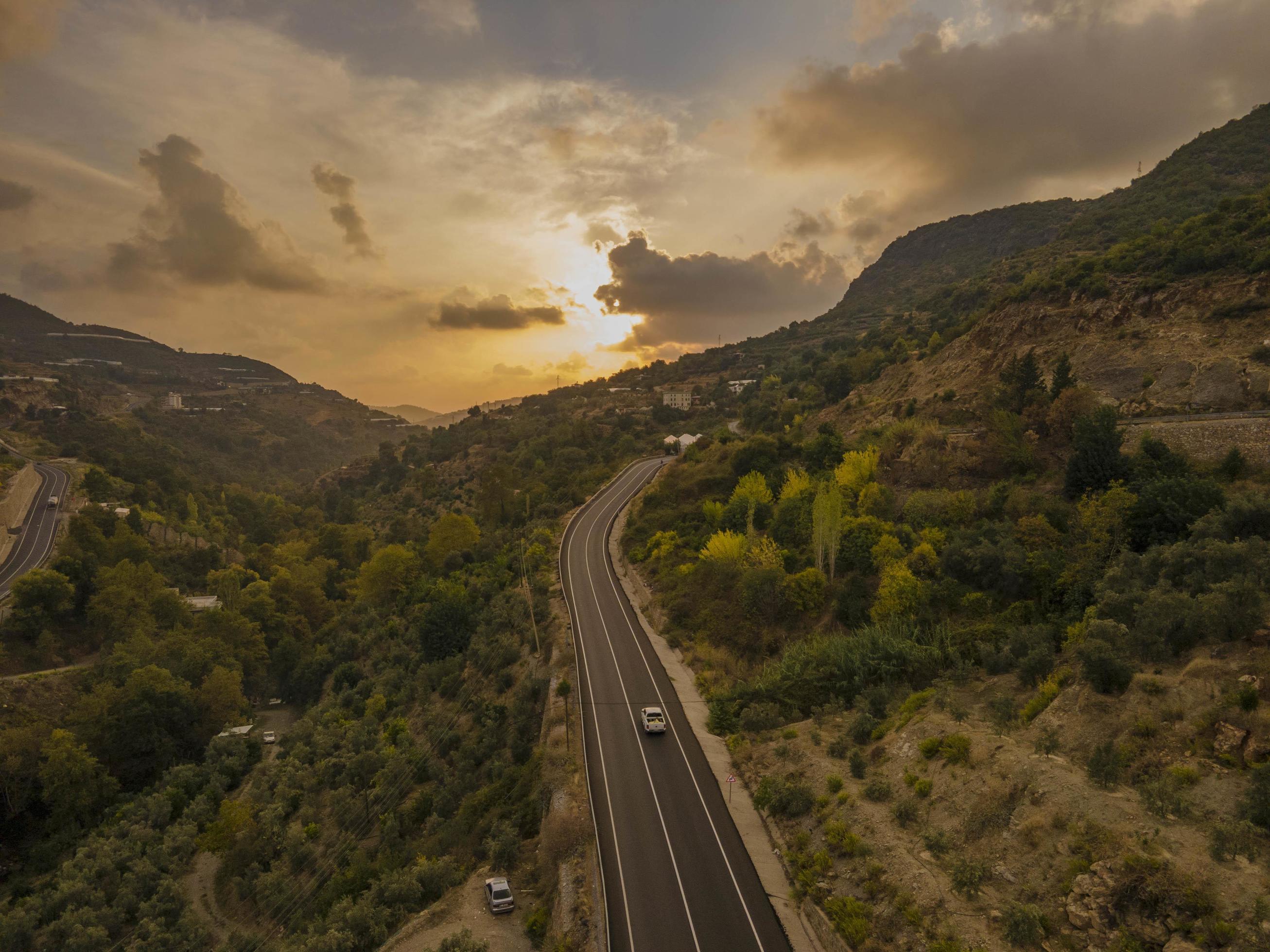 aerial valley and road, Top view, amazing nature background. sunset Flying drone, seascape Stock Free