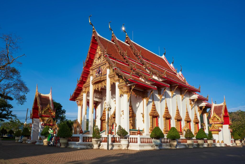 Chalong temple at Phuket province on blue sky background Stock Free