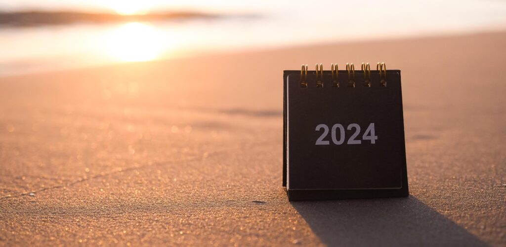 Close up 2024 desk calendar on the beach in the sunset time. Resolution, Goal, Action, Planning, and manage to success business. Stock Free