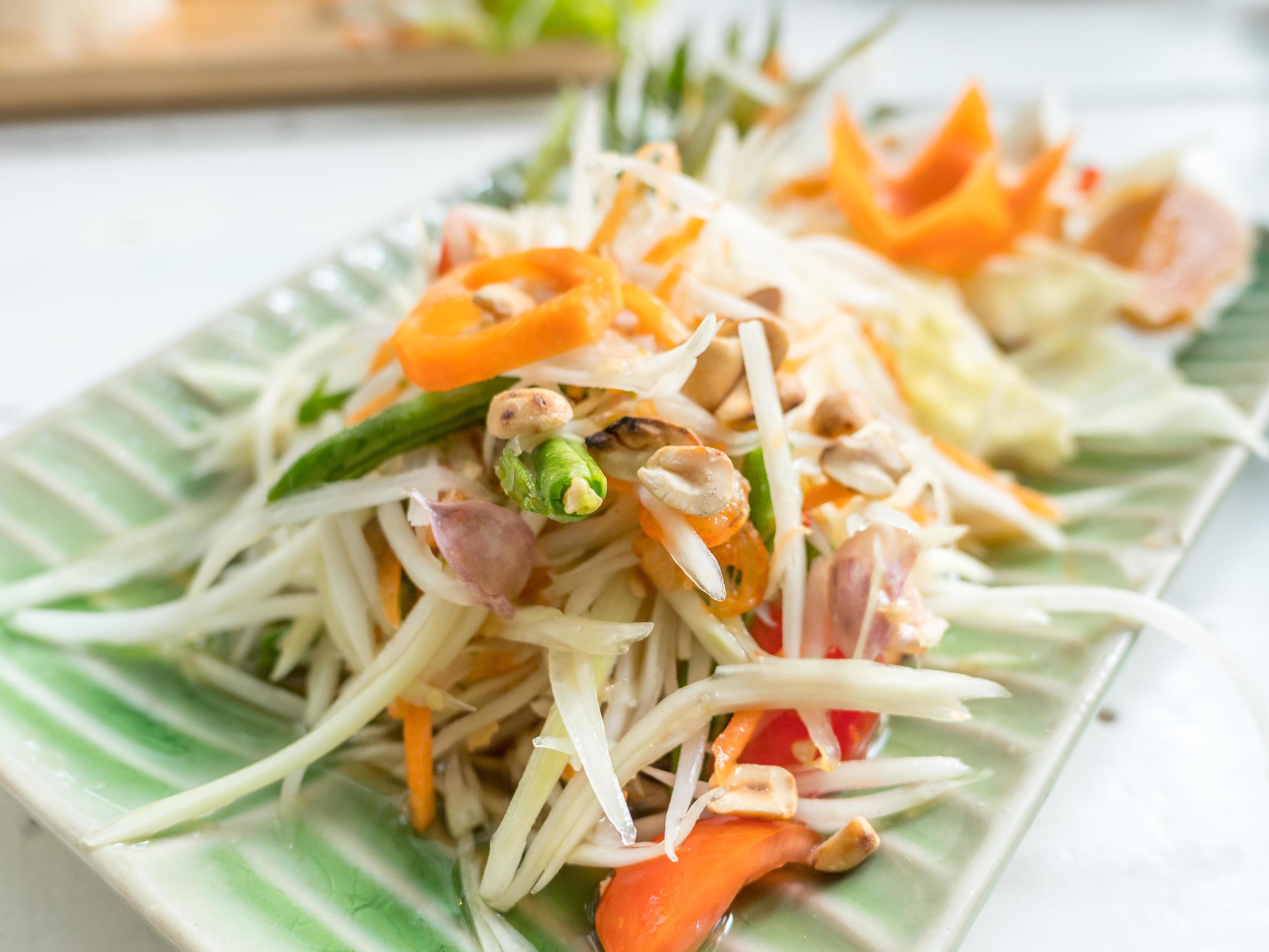 Papaya salad or Som tum, Thai food on table Stock Free