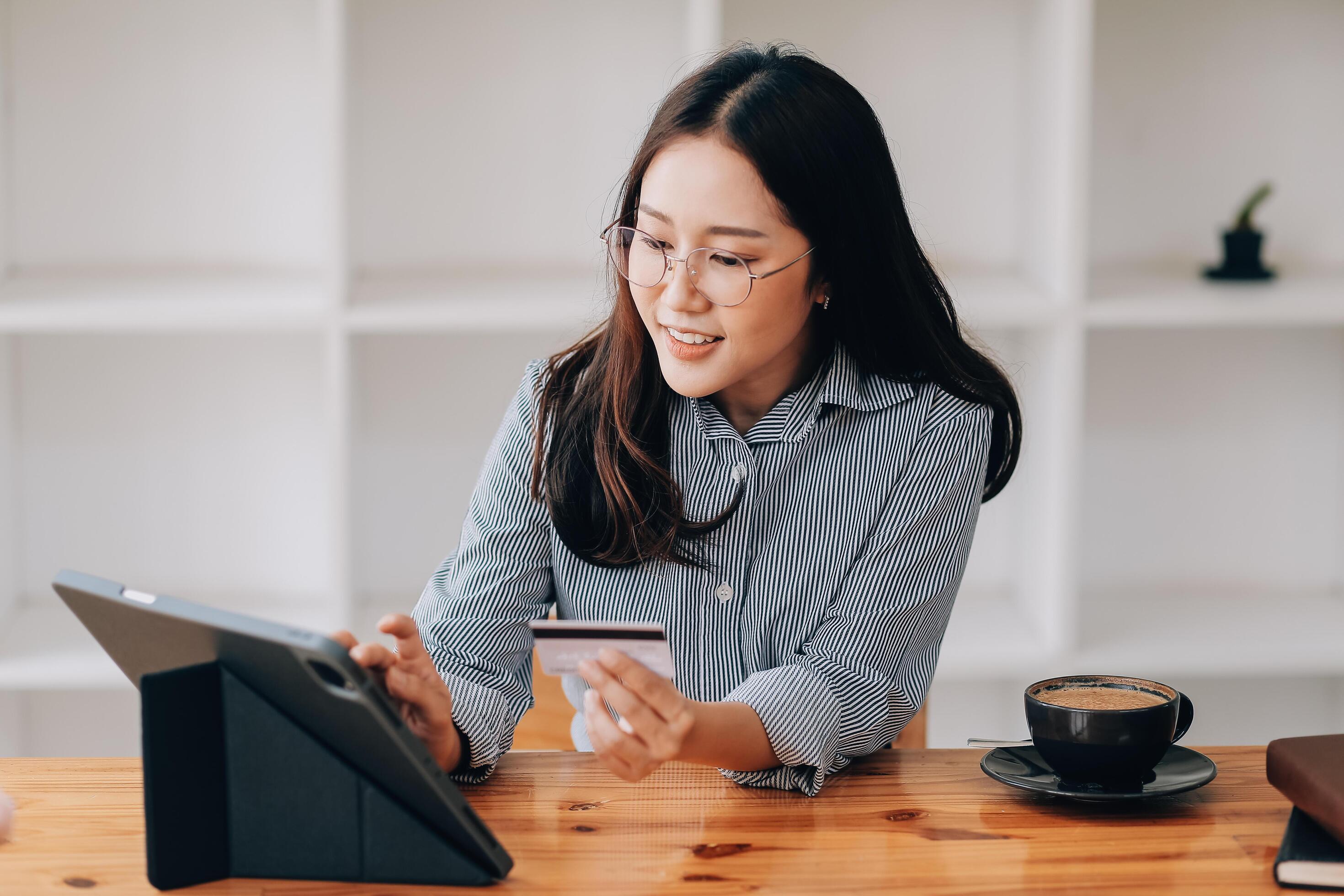 Happy asian woman using smartphone shopping online with credit card. Lifestyle. Easy pay using smart phone or digital device. Stock Free