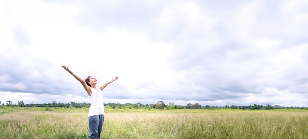 Asian women travel relax in the holiday. on a green pasture. Stock Free