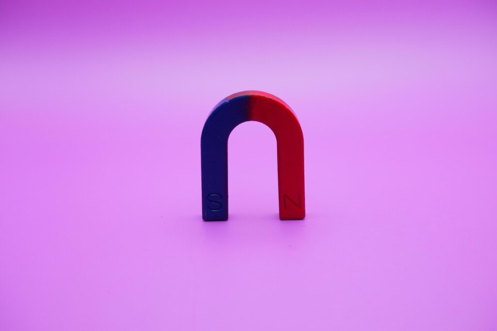 Horseshoe magnet isolated on purple background Stock Free