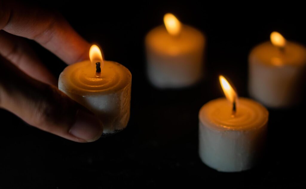 Candles light. Christmas candles burning at night. Abstract candles background. Golden light of candle flame. Stock Free