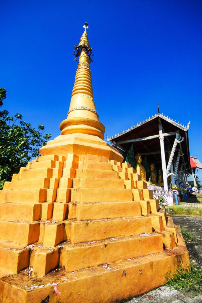 Golden pagoda detail is Mon architectural style at temple located in Kanchanaburi Province, Thailand. Stock Free