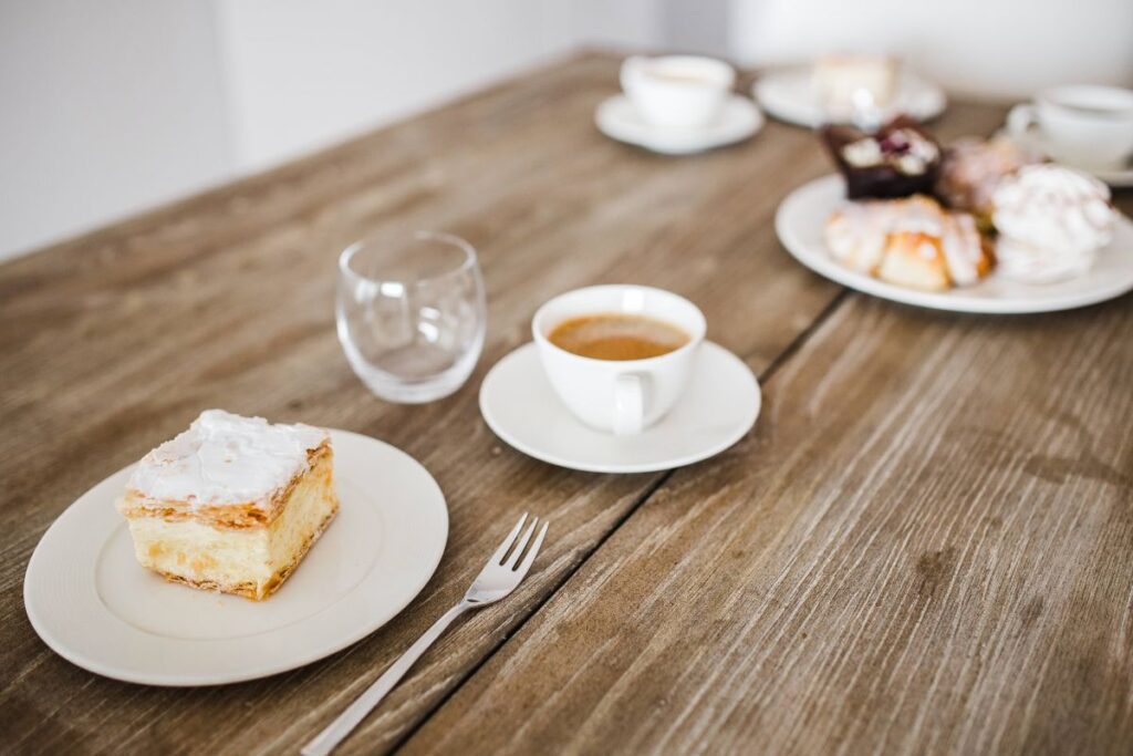 
									Sweet dessert with cream and a cup of coffee on a table Stock Free