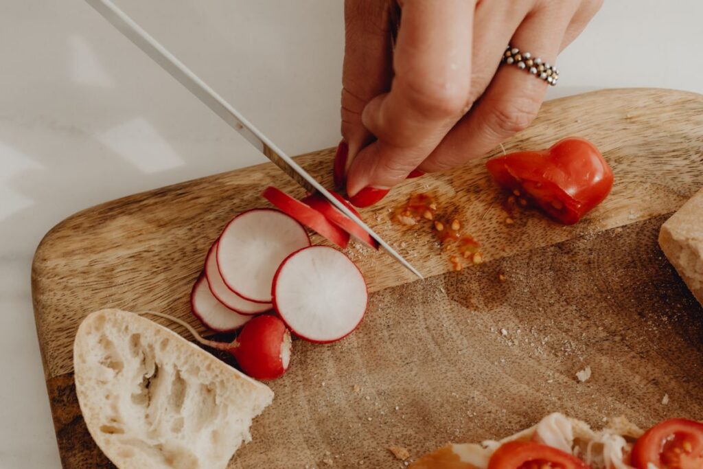 Woman making bruschetta with healthy ingredients Stock Free