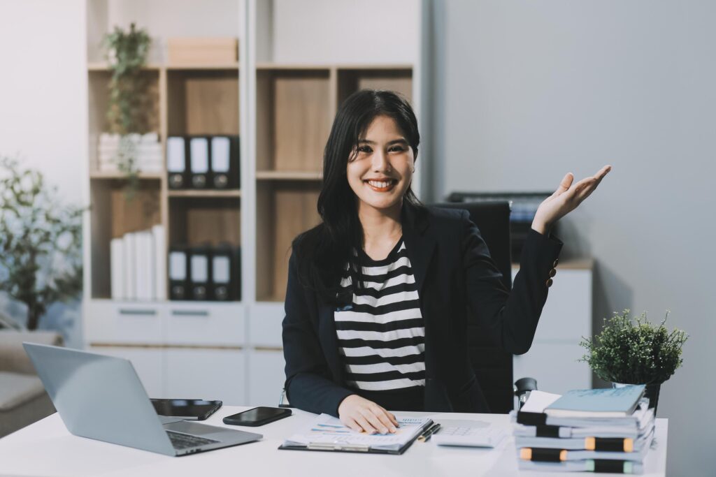 Young pretty business woman with notebook in the office Stock Free