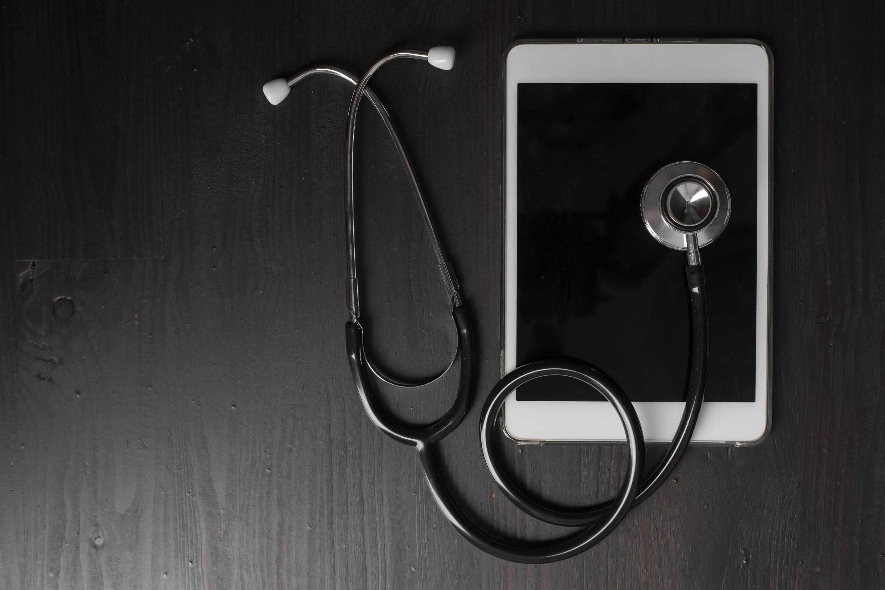 Close-up of medical stethoscope on tablet computer Stock Free