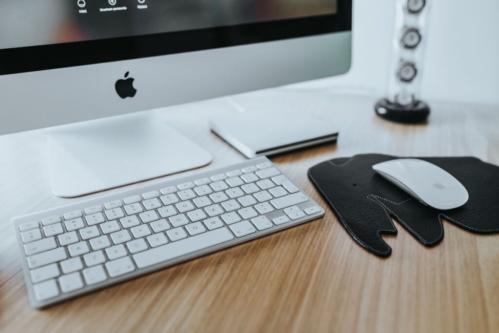 White Apple iMac computer with elephant mousepad Stock Free