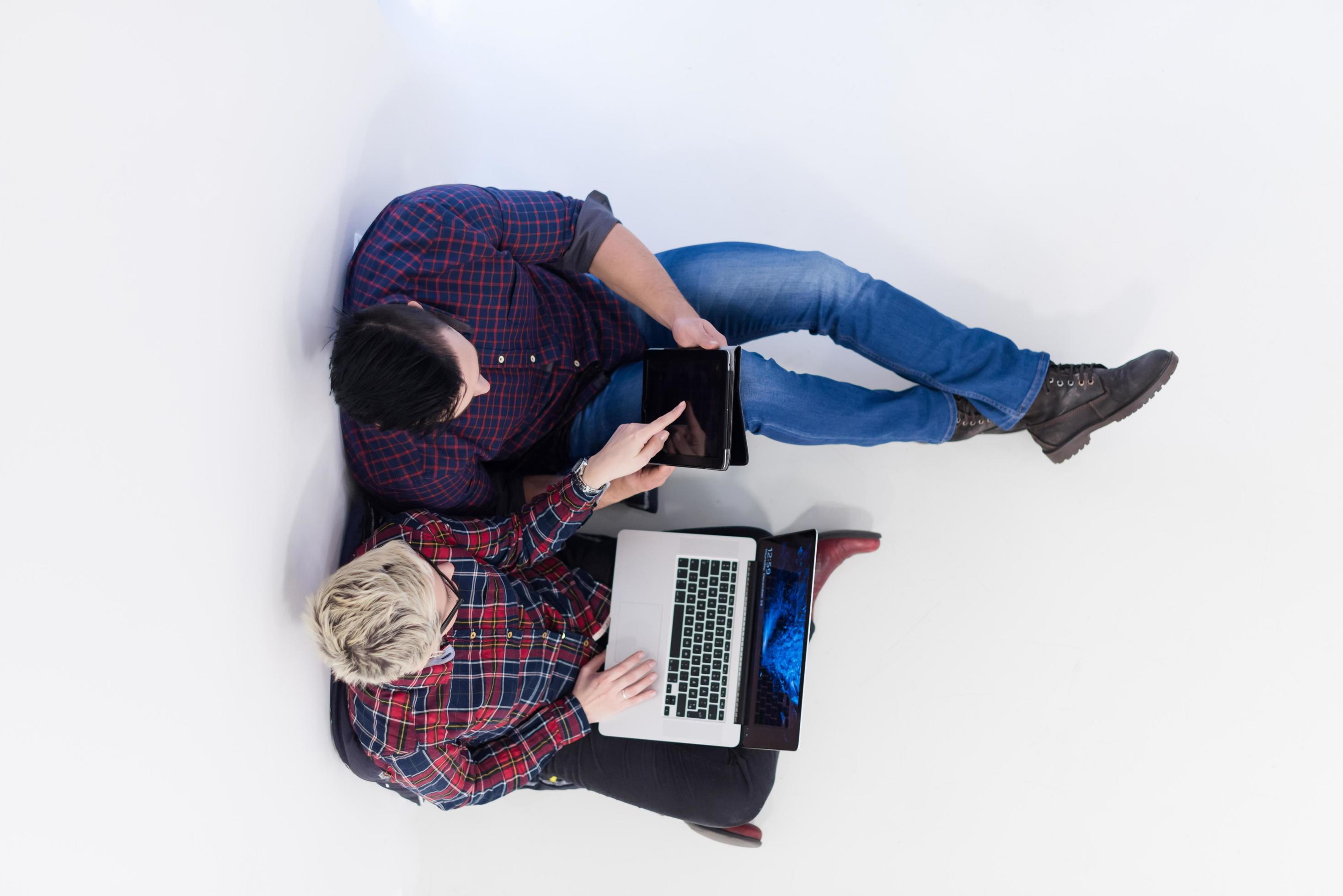 top view of couple working on laptop computer at startup office Stock Free