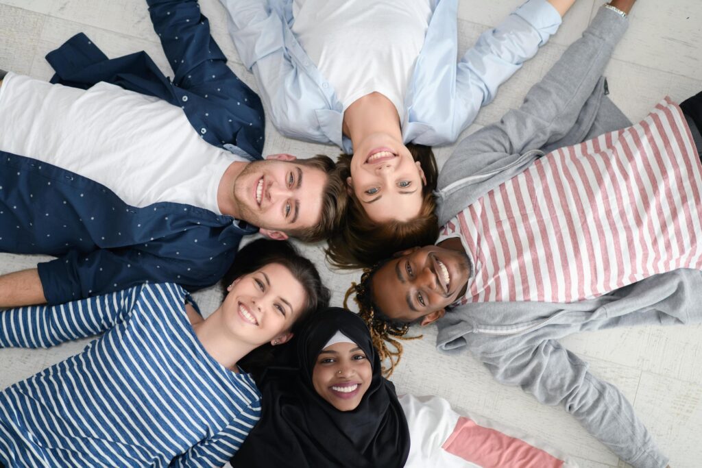 
									top view of a diverse group of people lying on the floor and symbolizing togetherness Stock Free