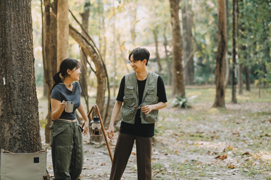 Asian couple sweet in tent inside on they camping trip, traveller relax and sleep togather in out door and camping trip Stock Free