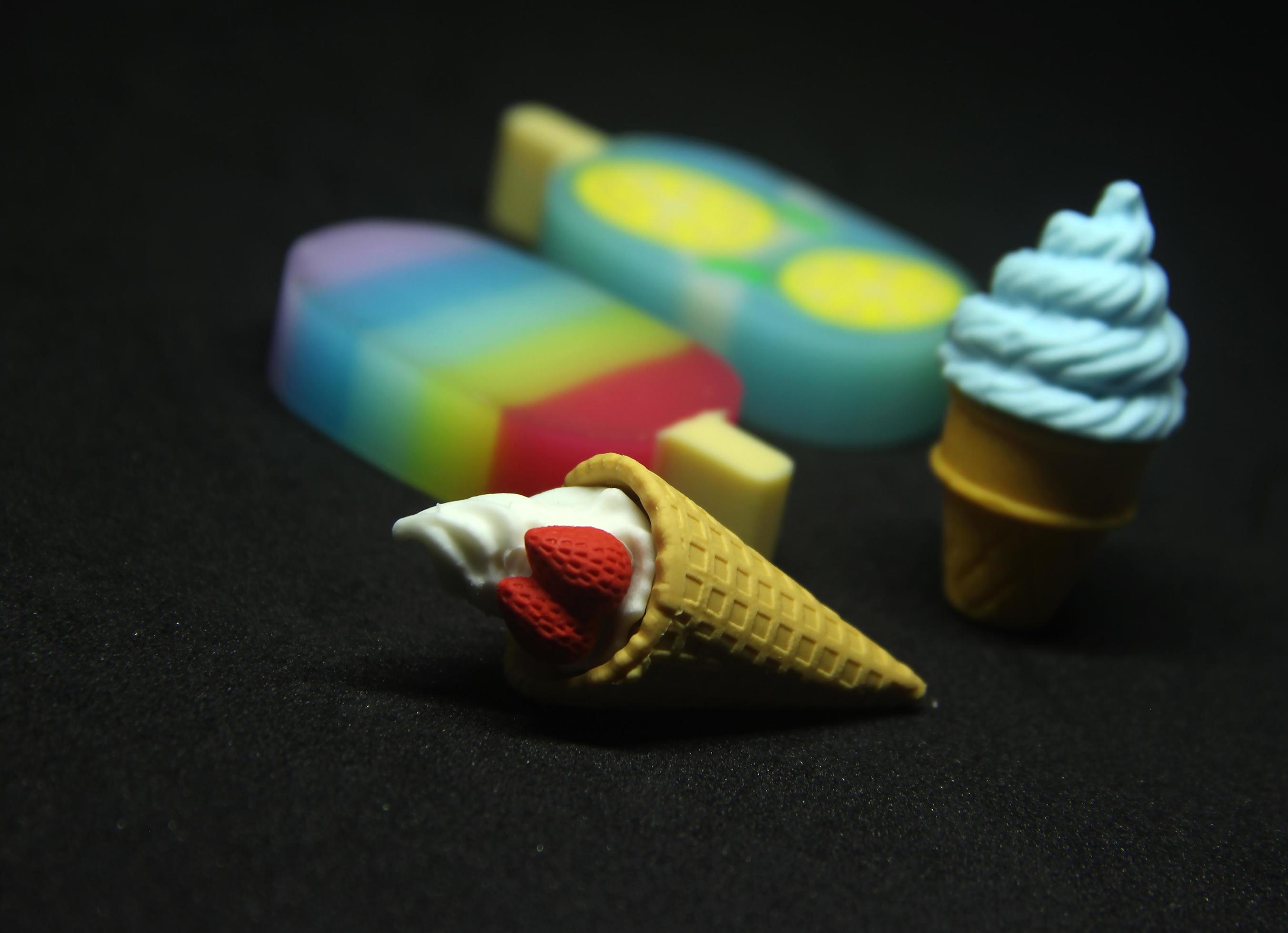 Summer food shaped eraser. School or office stationary tool supplies with ice cream cone and popsicle shape. isolated photo on dark black background. Stock Free