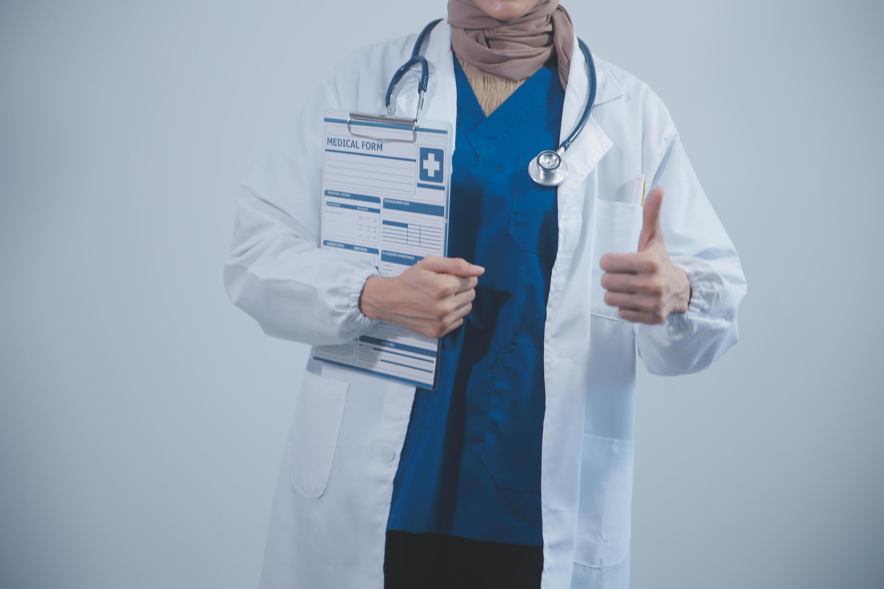 Doctor holding clipboard and stethoscope on background of Hospital ward Stock Free