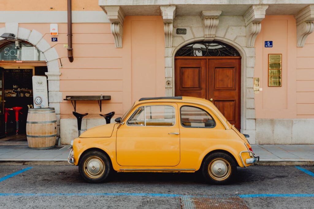 Classic Fiat 500 car parked on the street in the town of Trieste, Italy Stock Free