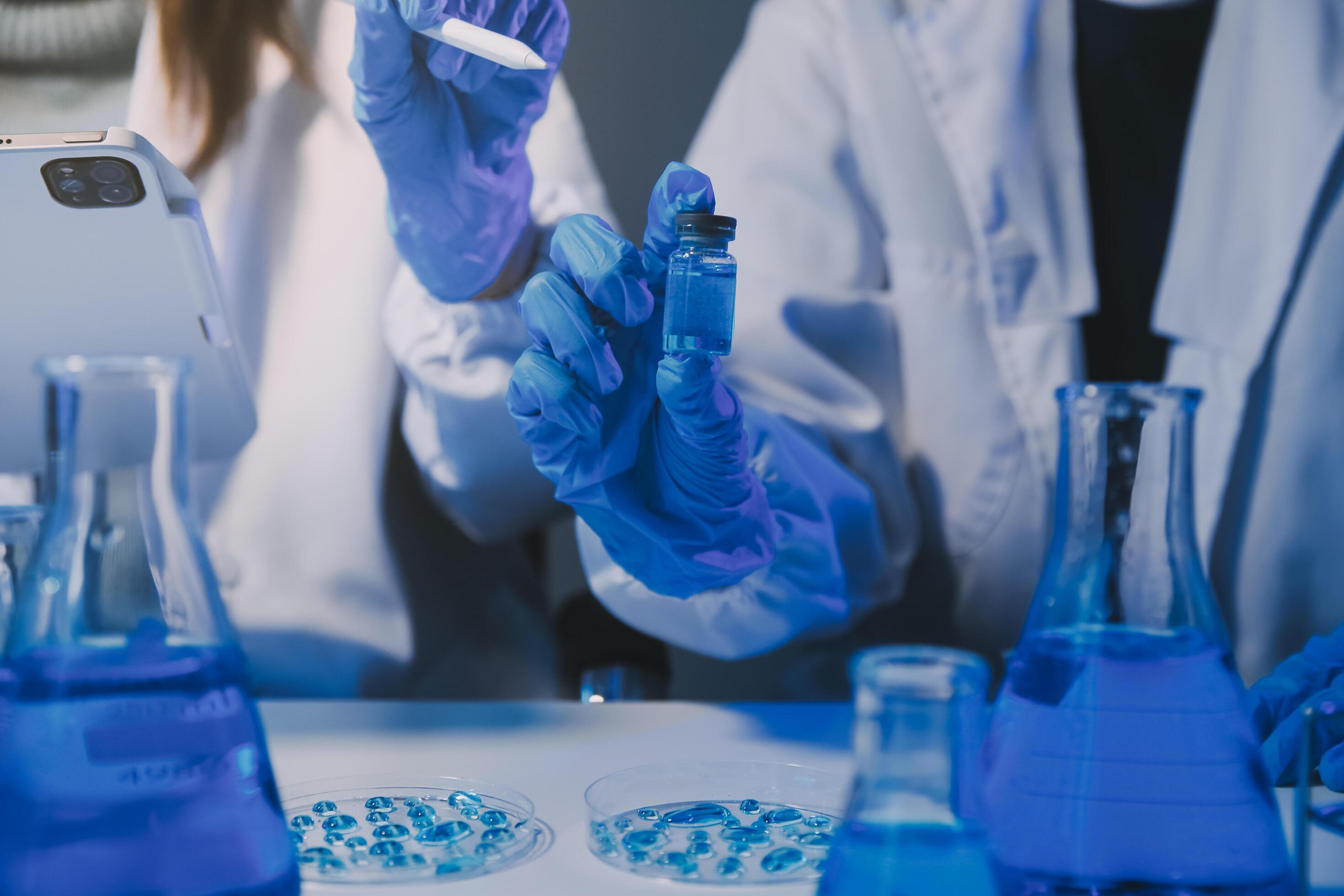 chemist,scientist hand dropping chemical liquid into test tube, science research and development concept Stock Free