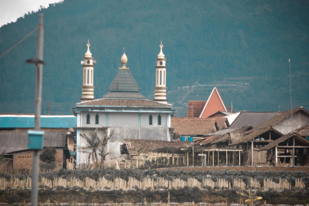 photo of the mosque which is on the slopes of the mountain Stock Free