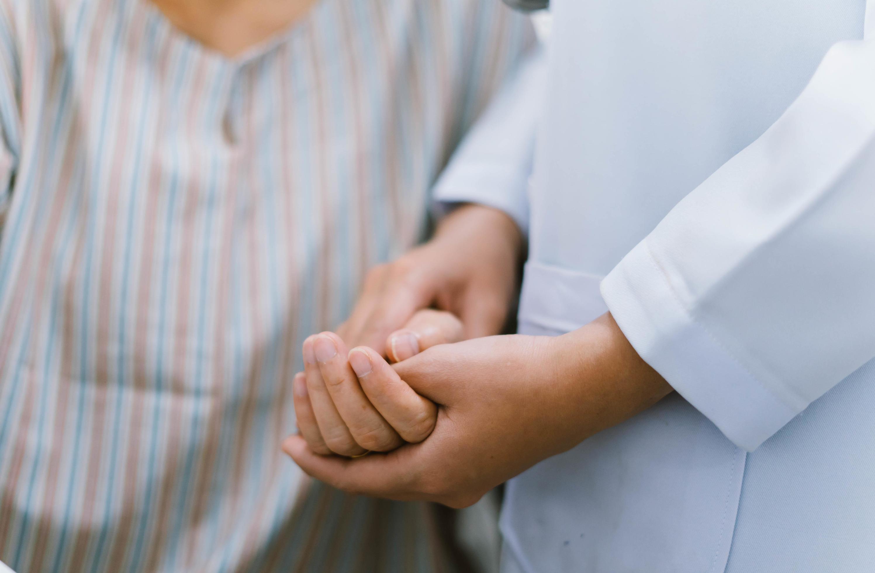 close up doctor hold hand of senior patient , medical care responsibility Stock Free