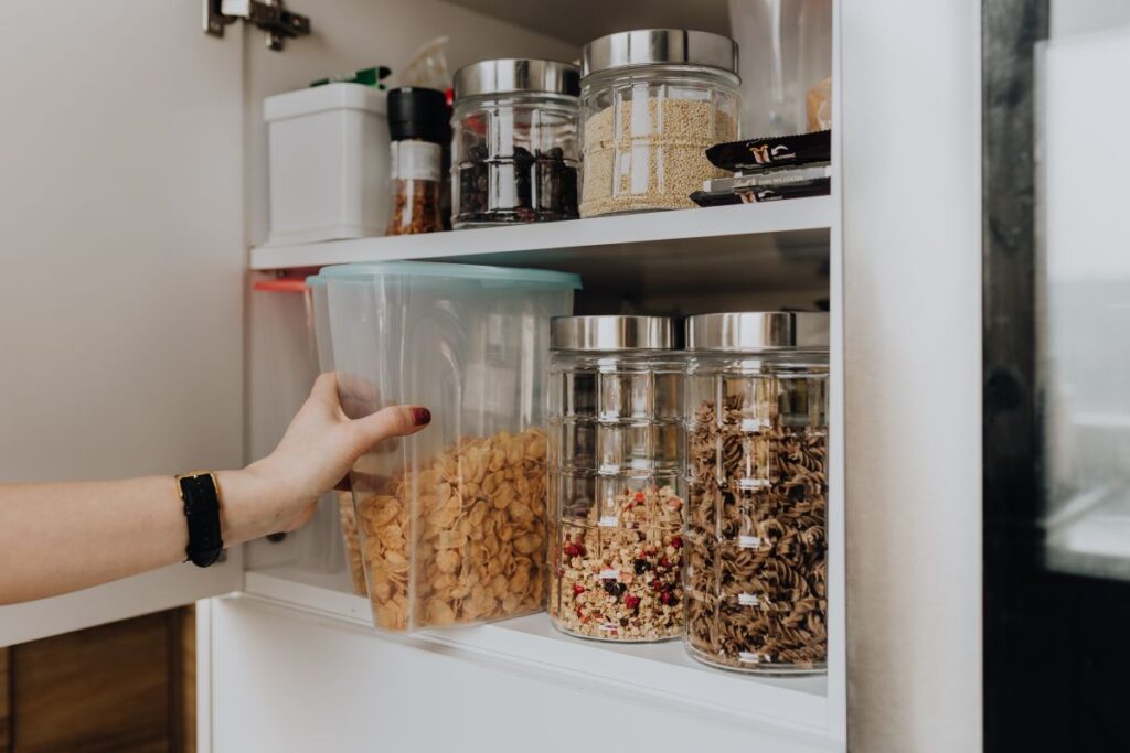 Containers of cereals in kitchen cupboard Stock Free