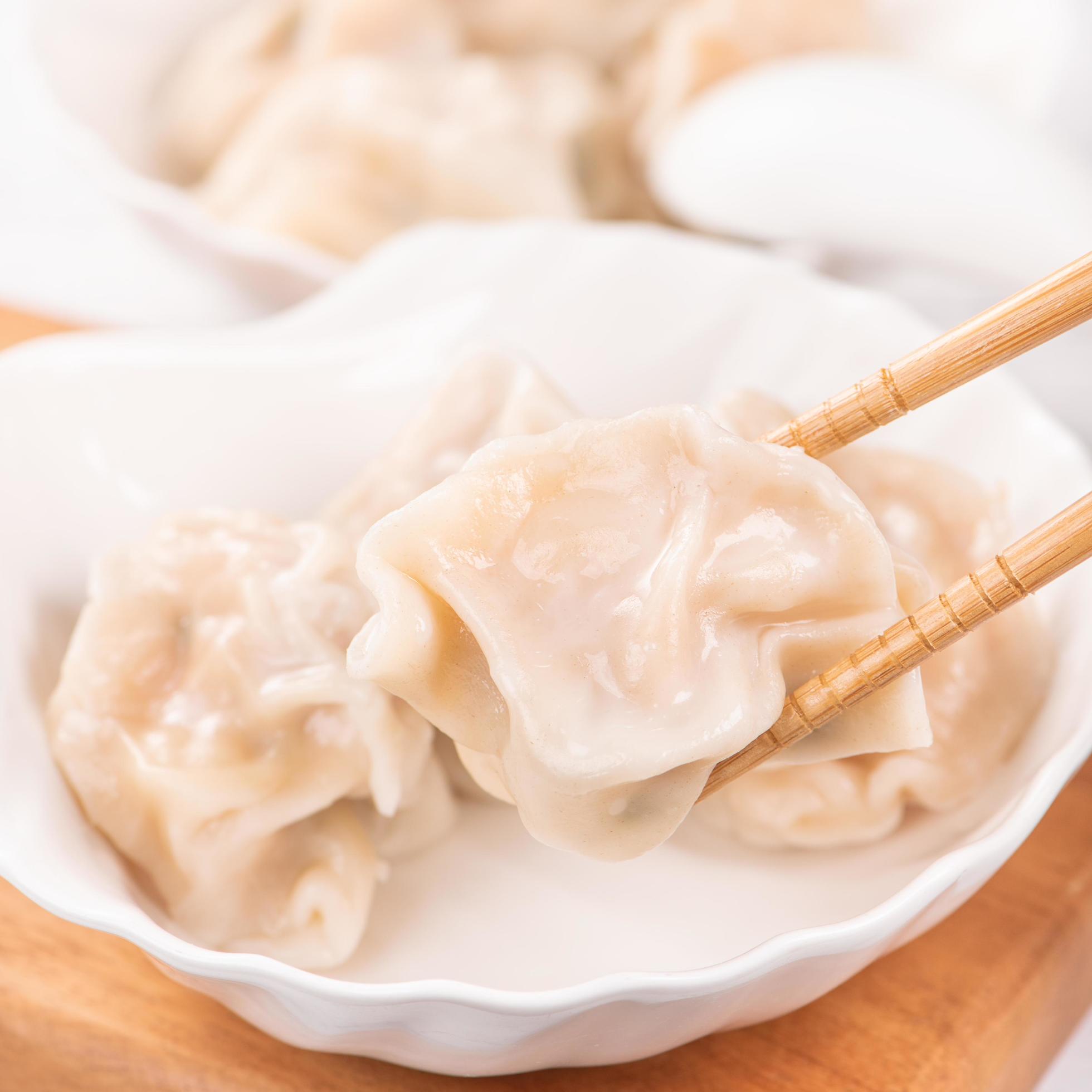 Fresh, delicious boiled pork, shrimp gyoza dumplings on white background with soy sauce and chopsticks, close up, lifestyle. Homemade design concept. Stock Free