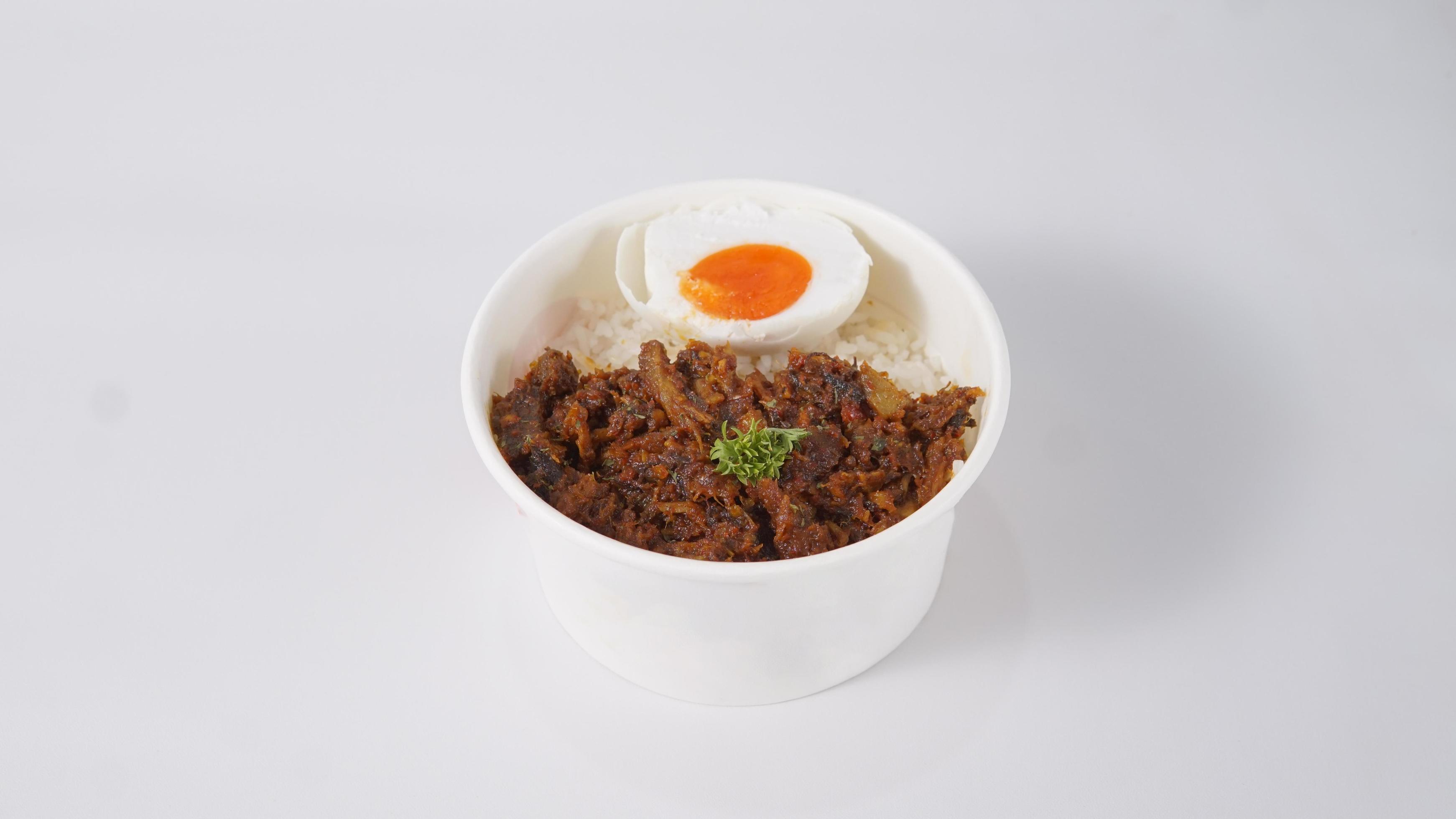 Rice topped with keumamah fish, traditional aceh indonesian food and eggs on a white background Stock Free