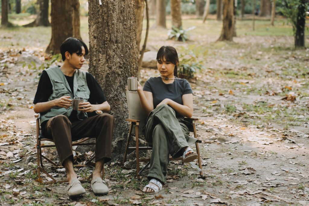 Asian couple sweet in tent inside on they camping trip, traveller relax and sleep togather in out door and camping trip Stock Free