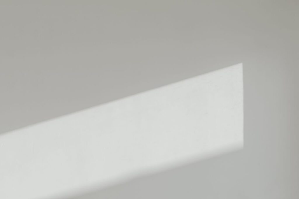 Sunlight on a white wall – minimalist wallpaper – background Stock Free