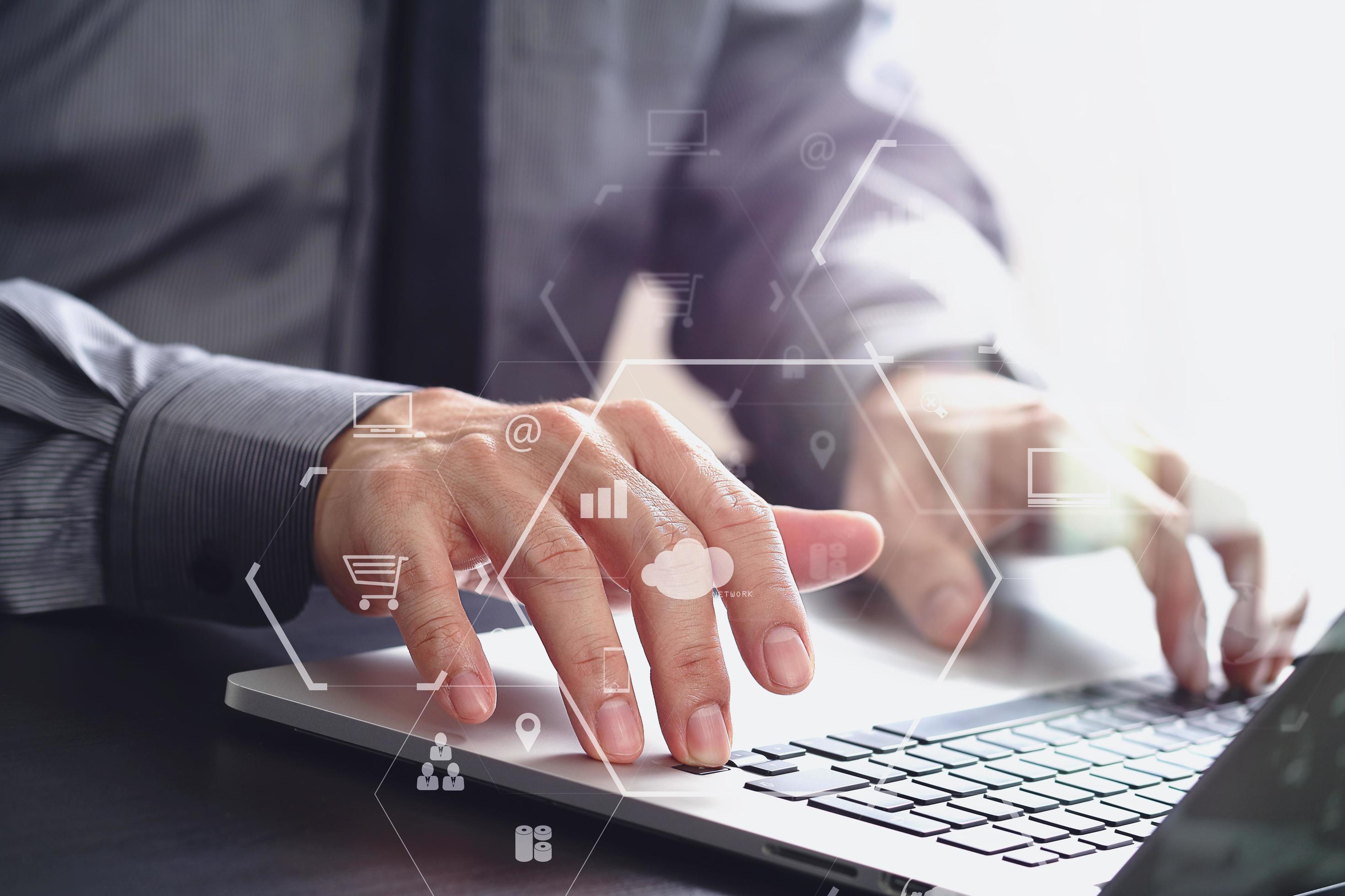 close up of businessman working with laptop computer on wooden desk in modern office with virtual icon diagram Stock Free