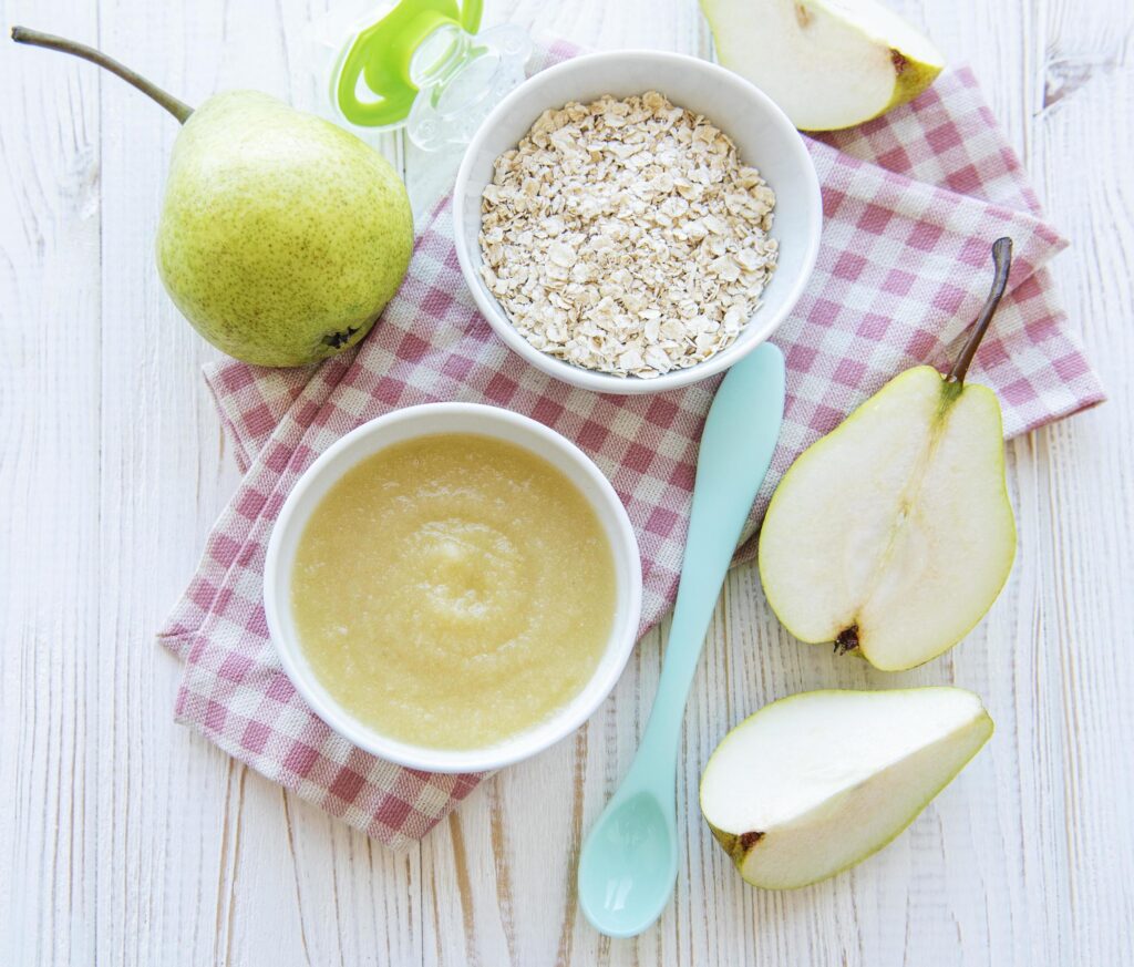 Bowl with fruit baby food and pears Stock Free