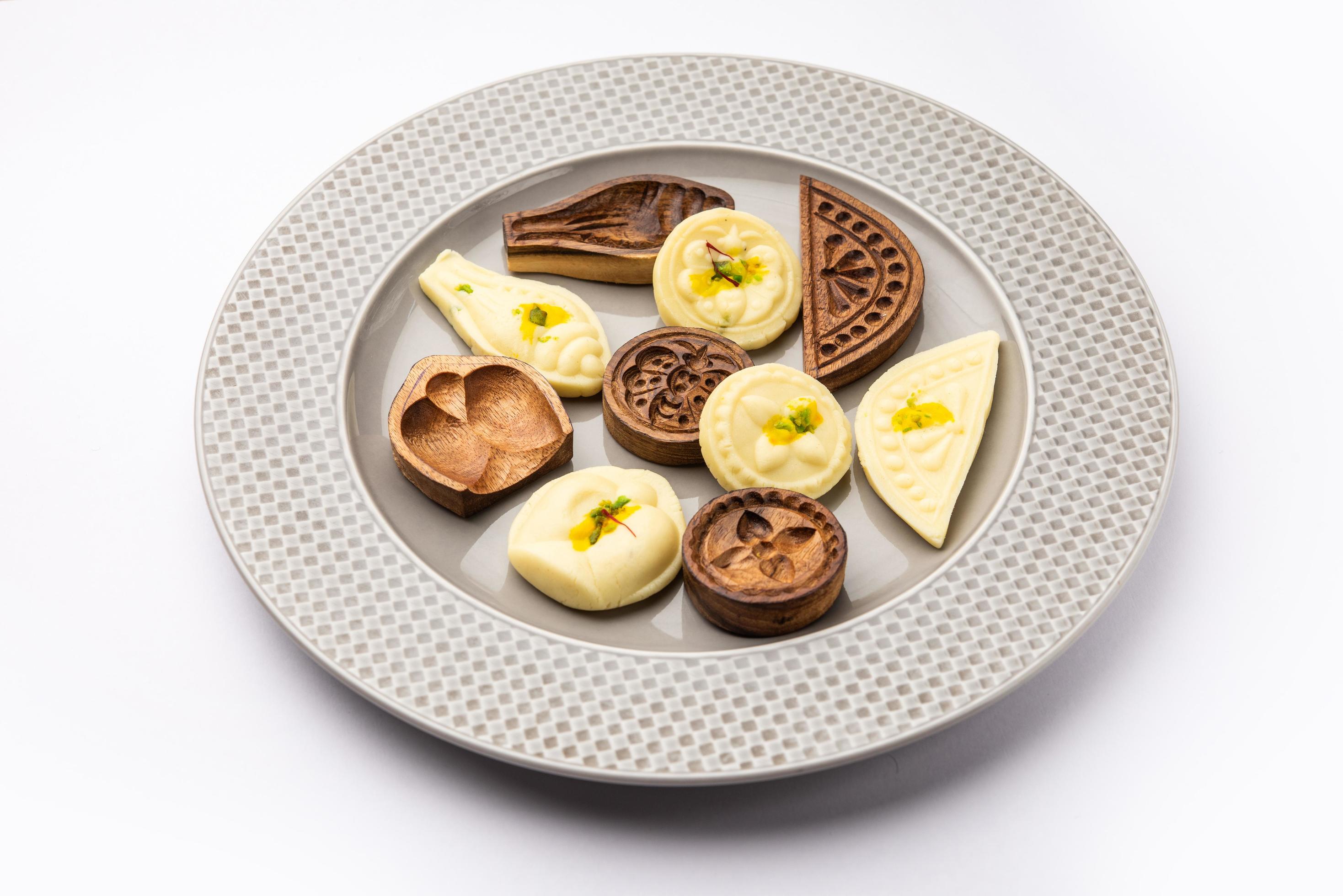 Sandesh or Shondesh sweet food with wooden moulds in a plate Stock Free