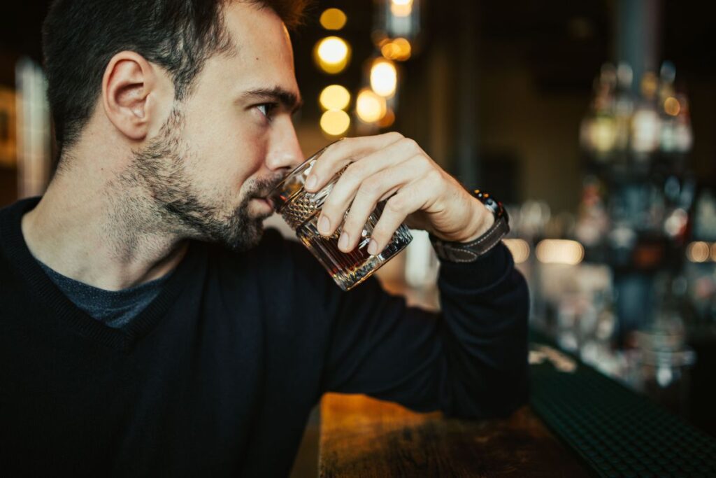 Handsome young man in a pub Stock Free