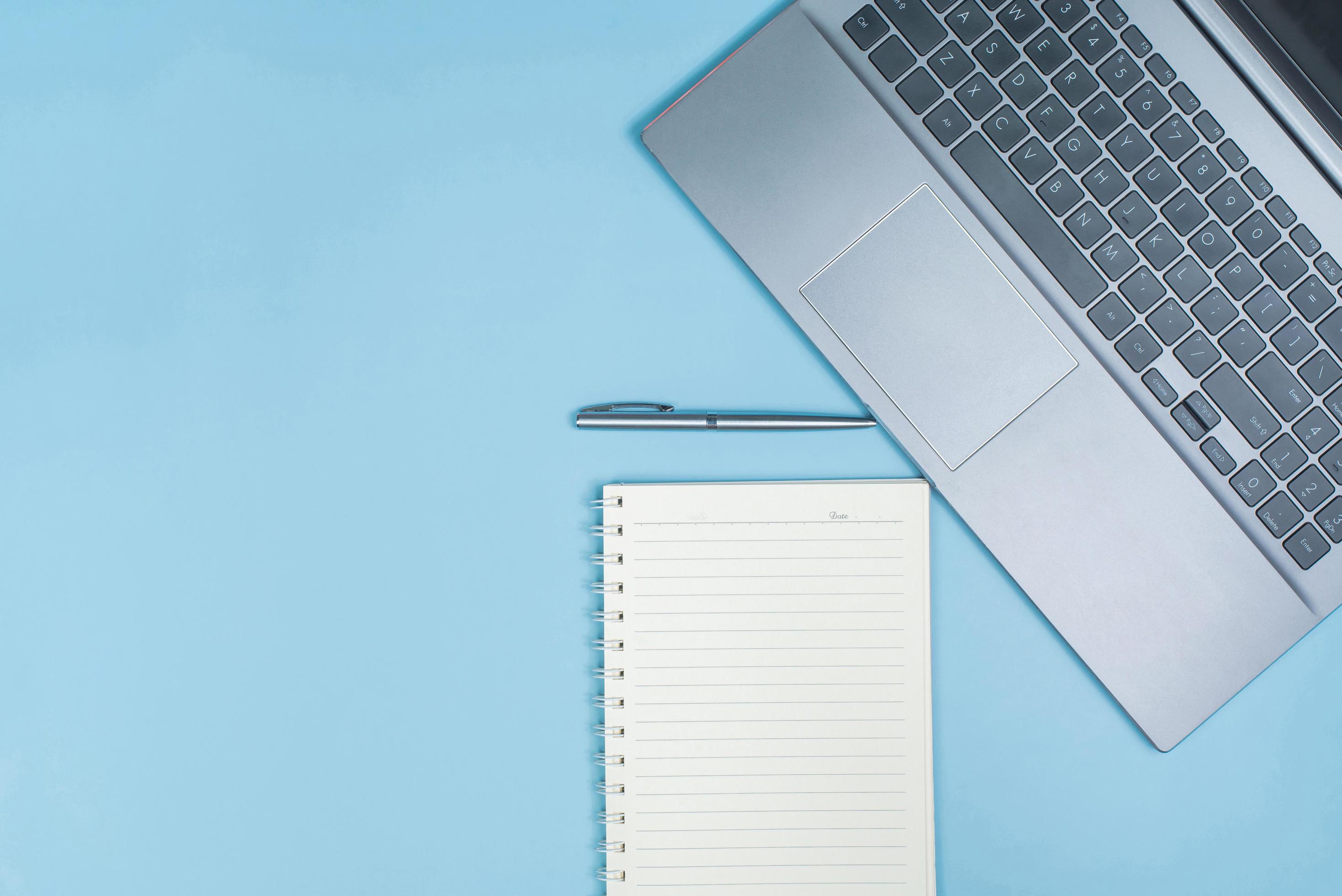 Top view of Office Table top with laptop computer, pen and notebook with space Stock Free