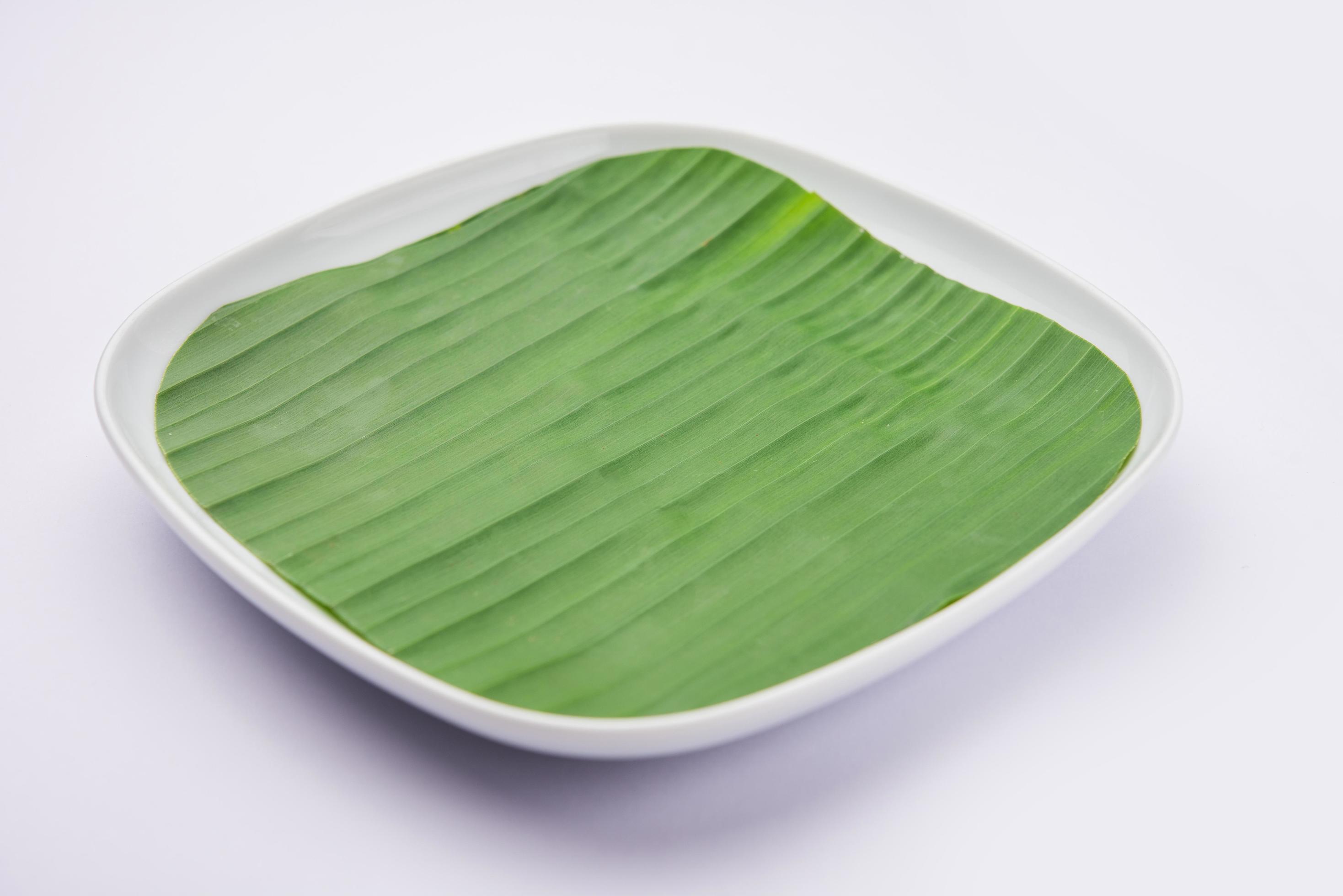 banana leaf on blank plate for edit food or subject on Stock Free