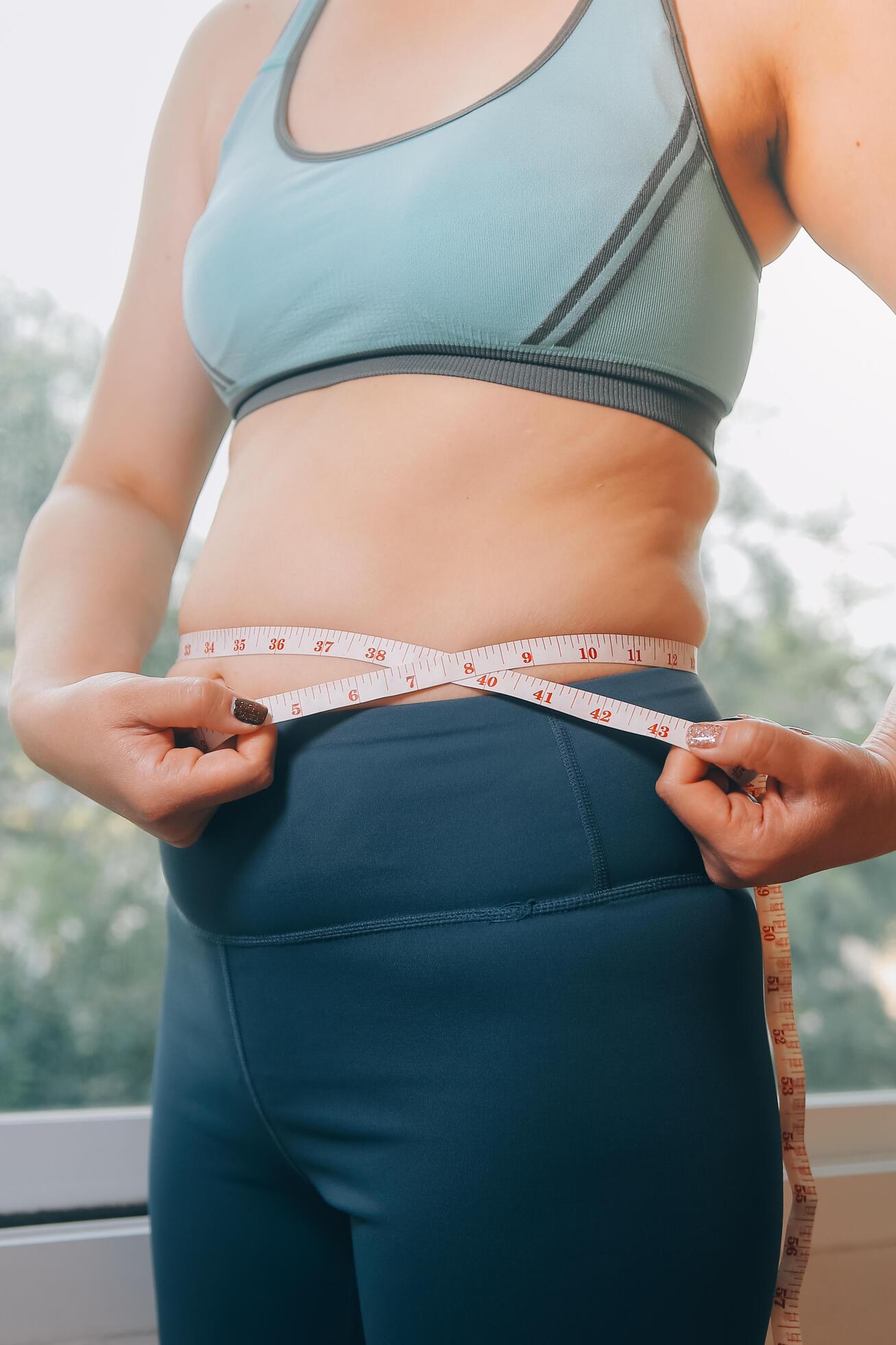 fat woman, fat belly, chubby, obese woman hand holding excessive belly fat with measure tape, woman diet lifestyle concept Stock Free